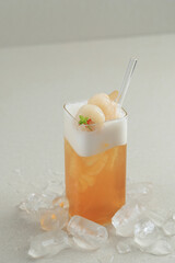 Wall Mural - Lychee Iced Tea with Mint Leaves in a Glass with Glass Straw