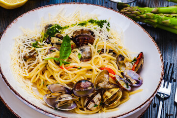 Wall Mural - Italian food. Seafood pasta with clams. Spaghetti alle Vongole on white plate.