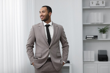 Wall Mural - Portrait of smiling young man in office. Lawyer, businessman, accountant or manager