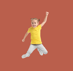 Wall Mural - Happy cute girl jumping on dark coral background