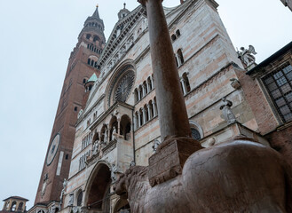 View of the cathedral of <cremona from one of the 6 column-bearing lions present among the sculptures supporting the columns.