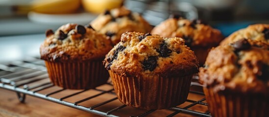 Canvas Print - Recipe idea for breakfast or a snack: muffins with banana and chocolate chips on a rack.