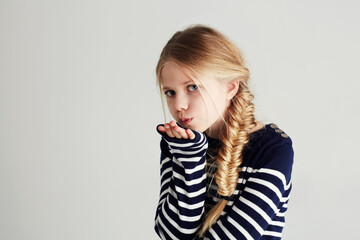 fashion, kiss and portrait of child in a studio with casual, cool and stylish outfit and hat. happy,
