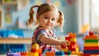Smiling girl with pigtails creatively plays with colorful building blocks in a sunlit playroom.
