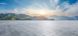 © ABCDstock - Empty square floor and green mountain with sky clouds at sunset. Panoramic view.