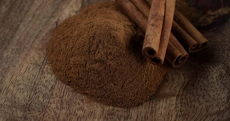 Wall Mural - Heap of cinnamon sticks and cinnamon powder, rotation