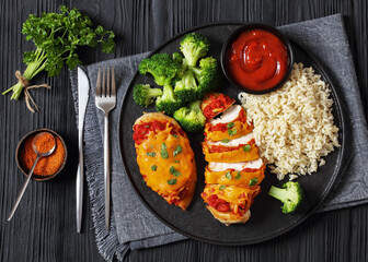 Wall Mural - baked chicken breasts with rice, broccoli on plate