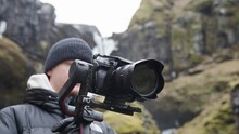 Male videographer hold electronic gimbal with camera in Icelandic landscape