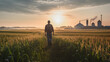 Farmer walks through corn field at dawn, grain silo in the distance, depicting rural life and agriculture