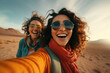 two women were taking a selfie in the desert while wearing sunglasses
