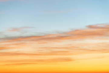 Wall Mural - The dramatic colors of the sunset in the sky gradient from blue to orange.