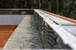 reinforcement belt filled with cement in the formwork, insulated from the side, close-up with partial sharpness, construction of a private house