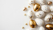 Beautiful easter background with painted golden decoration on easter eggs on white table. Top view and flat lay style.