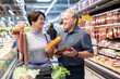 © caftor - Elderly man and elderly woman choose sausage