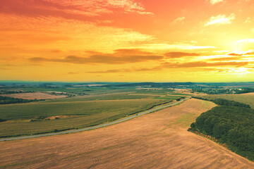 Wall Mural - View of the arable field during sunset. Rural landscape