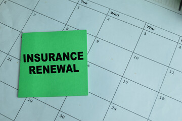 Wall Mural - Concept of Insurance Renewal write on sticky notes isolated on Wooden Table.