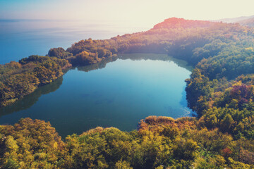 Wall Mural - Picturesque mountain lake in autumn. Lake against the sea. Beautiful wilderness. Aerial view