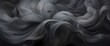 Charcoal gray silk swirling artistically, creating a moody and mysterious atmosphere