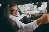 Fototapeta  - Close up adult man customer male buyer client in shirt sit drive electric car look camera seat choose auto want buy new automobile in showroom vehicle salon dealership store motor show Sales concept