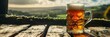 Glass of cold refreshing beer against blurred background of nature landscape. Relaxing in countryside, enjoying summer, vacation and nature beauty. Panoramic banner, header with copy space. Ireland