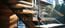 Glass And Steel Rail On Wooden Steps Of Solid Newel Stairs.