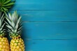 Ripe pineapples with copyspace on wooden background