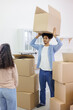 © MyJuly - African American couple, man and woman, collect clothes and personal belongings in cardboard boxes for moving. happy young people relocating to new home. purchase of residence, mortgage or rental.