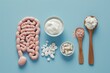 Artistic intestines applique on blue background depicts digestive health. Three spoons with yogurt, capsules, and powder symbolize probiotics and gut wellness