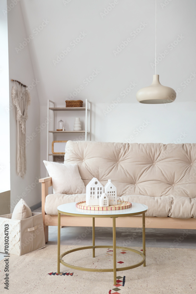 Interior of light living room with couch and table