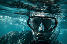 Guy in a diving mask with a breathing tube underwater