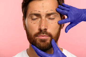 Poster - Doctor checking patient's face before cosmetic surgery operation on pink background, closeup