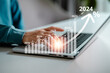 Businesswomen use laptop to analyze investment with increase arrow graph, chart, forecast economic graph growth percent for 2024, opportunity corporate future growth, financial and investment concept.