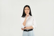 © Illhamt - An Asian woman in a white blouse places her finger on her lips, signaling 'Be quiet.' Her serious expression contrasts with the plain white background.
