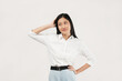 © Illhamt - An Asian woman in a white blouse crosses her hands in a determined gesture. She portrays confidence and focus against a plain white background.
