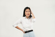 © Illhamt - An Asian woman in a white blouse touches her head with a thoughtful smile. The clean white background highlights her approachable and professional demeanor.