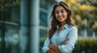 © Rumi X - corporate businesswoman stands smiling outside her office building