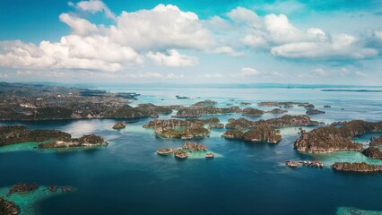 Poster - Aerial view Raja Ampat region in Indonesia. Seascape with lots of islands and calm turquoise lagoons near the Misool island, Indonesia