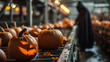 Devil in black cloak work with Pumpkins with halloween scary face on conveyor belt line, Distribution warehouse decorated with halloween props. E - commerce and storage of pumpkins.