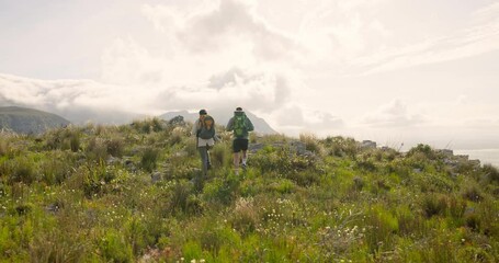 Wall Mural - back of couple trekking, walking on mountains and travel for adventure, wellness and health in natur
