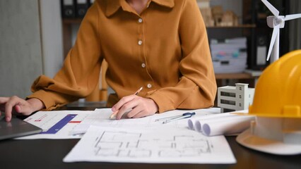 Wall Mural - creative architect projecting on the big drawings with architectural project at construction site at