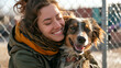A happy female help adopt a dog from dog rescue shelter. A dog is happy.