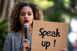Speak up concept image with a black afro american woman holding a sign board with written words speak up to fight against racism