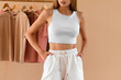 © AlexGo - Modern Fashion Trends. No-face woman wears a white crop top and white shorts. Contemporary Women’s Fashion with a Textured White Top. Woman Wearing a Stylish White Top Paired with a Skirt