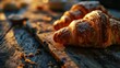 Sunset's warm embrace enhances the golden crust of freshly baked croissants on a rustic table