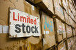 Fake scarcity concept image with huge wall of cardboard boxes with written limited stock on it for artificial scarcity
