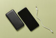 © splitov27 - Black power bank and smartphone on green background