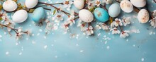 Frame With White And Blue Speckled Easter Eggs And Cherry Blossoms On Light Blue Background. Happy Easter Concept. Simple Spring Template, Greeting Card, Banner. Top View, Flat Lay With Copy Space