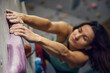 © master1305 - Young sportive woman, bouldering instructor with hands in powder, training, practicing indoors, climbing wall. Concept of sport, bouldering, sport climbing, hobby, active lifestyle, school, course