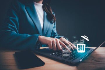 businesswoman using computer laptop or smartphone delete files from a computer or from the internet.