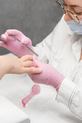 Wall Mural - Preparing nails for manicure. Manicurist doing gel nails for a client.